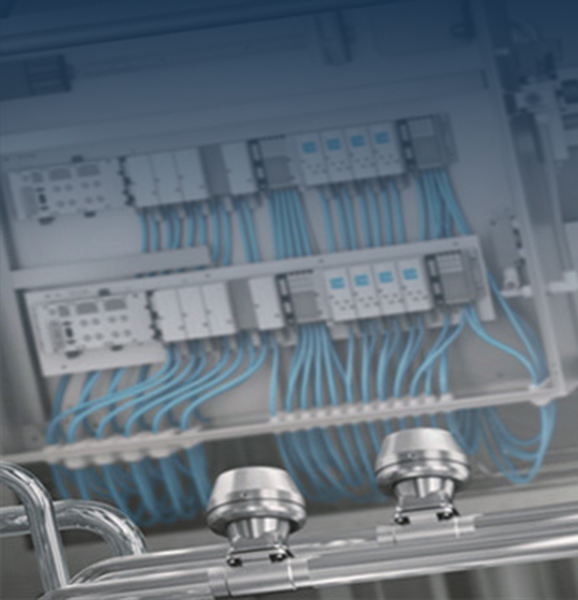 Pneumatics: valve terminals with compressed air hoses in a control cabinet